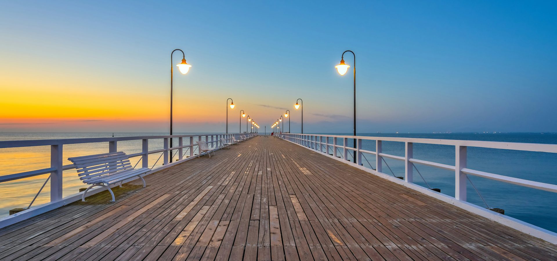 Waterfront structure at dusk over calm water